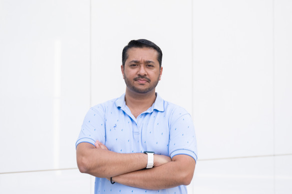 man standing with arms crossed, serious expression