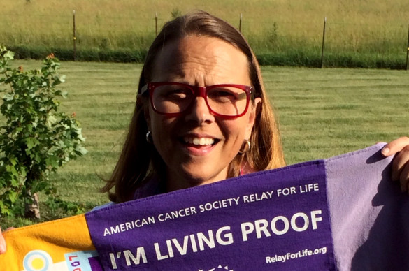 Julie Turner holding a relay for life banner