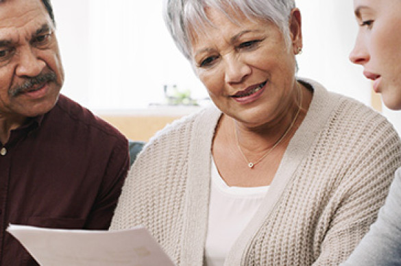 A man and two women reviewing medical information