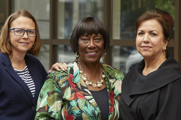 three volunteers looking at camera