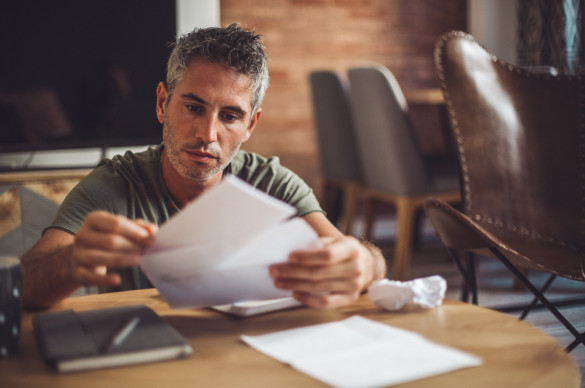 Man sitting with medical bills