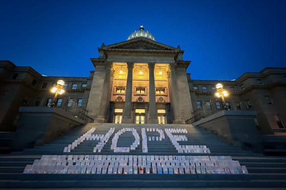 Idaho State Capitol steps at night lit up with lights of hope bags that spell out the word HOPE