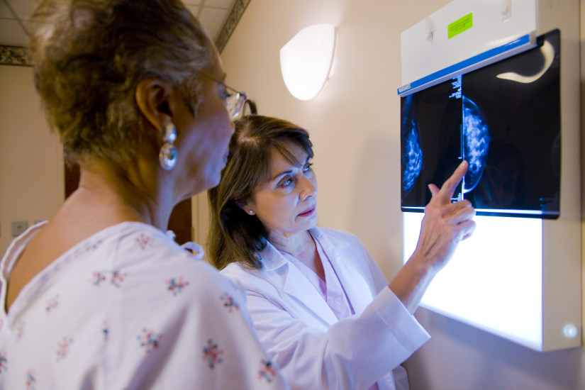 doctor showing patient breast cancer screening