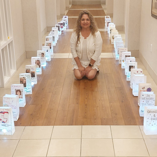 Alma González sits among Lights of Hope bags