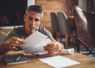 Man sitting with medical bills